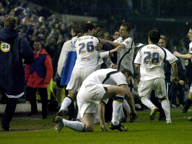 David Healy is mobbed by team mates after scoring the last gasp winner.