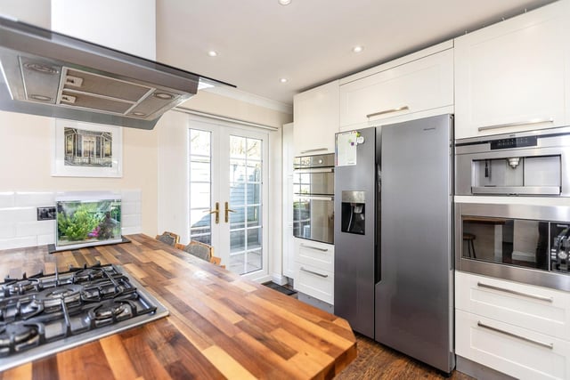 The modern fitted kitchen with integrated electric oven and grill, microwave oven and coffee machine, as well as plenty of space for an American style fridge freezer.