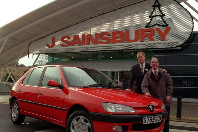 Sainbury's customer Arnold Abrams enjoyed an early Christmas present in December 1998 when local store manager Paul Robinson (left) handed over a new Peugeot 306. His name was randomly selected from over 2,000 entries for the car draw at the Moor Allerton store.