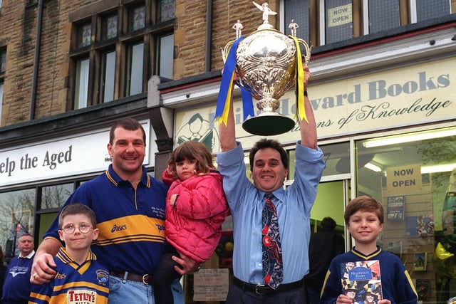 Author of Headingley Rugby Voices Phil Caplan holds aloft the Silk Cut Challenge Cup at the opening of Philip Howard Books on Street Lane in October 1999. He is watched by Leeds Rhinos forward Marc Glanville who opened the shop and some local children Oliver Munden (left) Christopher Collins and sister Rebecca.
