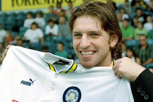 New signing Lee Sharpe holds up a Leeds United shirt after meeting fans at Elland Road. PIC: Bob Collier/PA