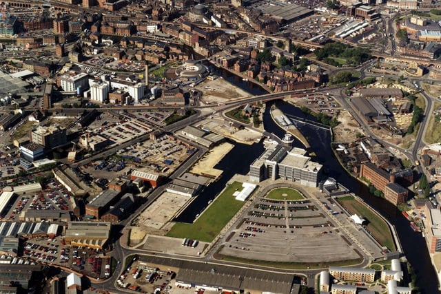 An aerial view showing the River Aire running from centre left to bottom right in October 1996. Clarence Dock and the recently opened Royal Armouries Museum can be seen in the centre.