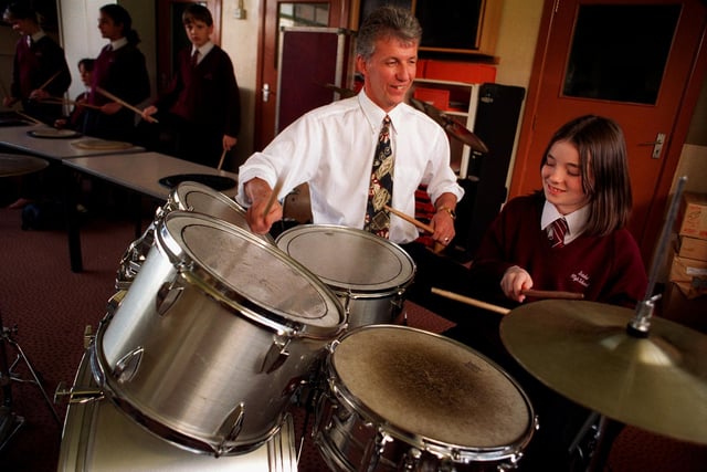 Dave Robbins, head of performing arts at Intake High School, with Keeley McCarthy on the drums in a Year 7 music class.
