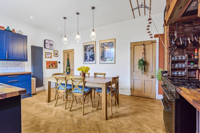 Central to the room is the large, rustic dining table with plenty of room for the family to enjoy. This space is accented by the feature pendant lighting. There is also an extra storage space leading out to the rear, a downstairs WC and a utility area.