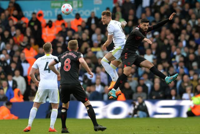 COMMANDING: Leeds United captain Liam Cooper soars to win a header under pressure from Armando Broja in Saturday's clash against Southampton at Elland Road upon his return from injury. Picture by Jonathan Gawthorpe.