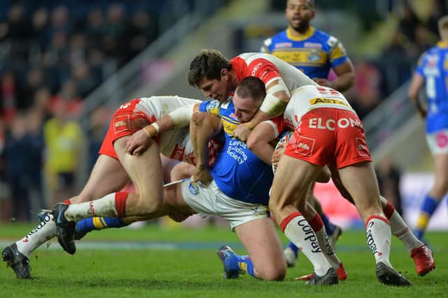Doing the splits: Leeds Rhinos’ Cameron Smith, centre, is nearly pulled apart by two St Helens players during another tough night at Headingley. (Picture: Bruce Rollinson)