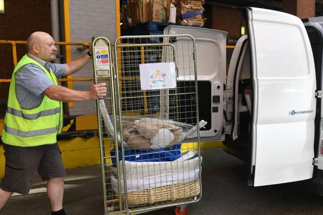 Tim Baxter the delivery driver for Leeds Baby Bank loading up the van