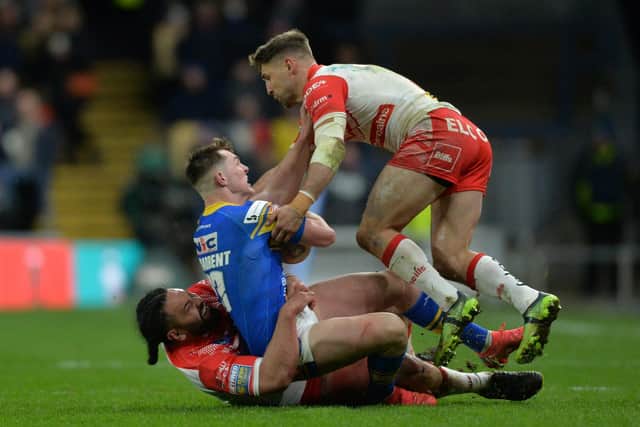 Jack Broadbent is tackled by former teammate Konrad Hurrell and Tommy Makinson. Picture by Bruce Rollinson.