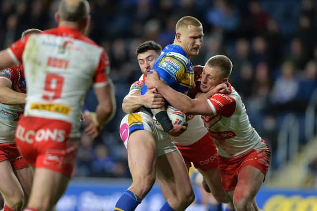 Mikolaj Oledski is held by St Helens' Dan Norman and Jake Wingfield in Leeds Rhinos' 26-0 defeat on Friday. Picture: Bruce Rollinson.