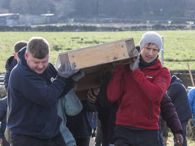 Volunteers carrying the cross up the hill