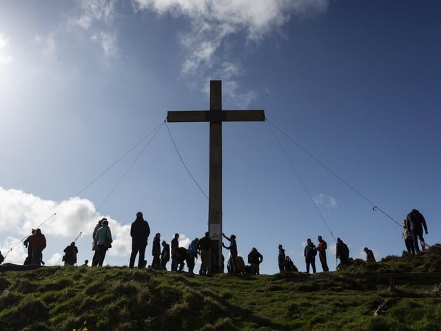 Volunteers help put the 30ft cross at the top of Otley Chevin hill each year.