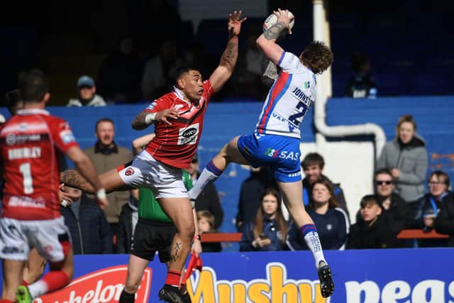 Tom Johnstone makes a brilliant catch before touching down for his first try. Picture by Jonathan Gawthoirpe.