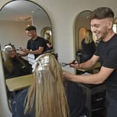 Kieren Kennedy, 24, with a client at his Cross Gates salon House of Kennedy (Photo: Steve Riding)