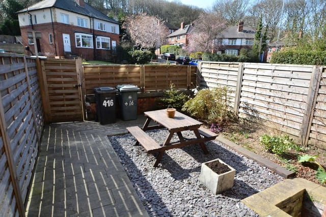 Outside to the front of the property is a sunny, landscaped garden.