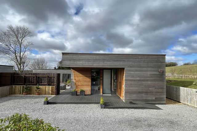 The resulting single storey house is L-shaped and is constructed from structural insulated panels.