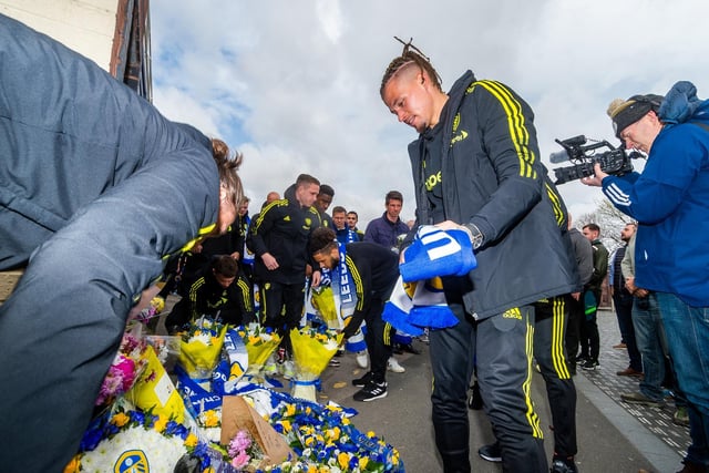 Kalvin Phillips lays a scarf during the memorial service