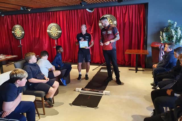 Joe Cullen, right, with Gary Horsley from Nottingham College's Room 180 Academy and Park Spring Primary School pupils during their Bullseye maths lesson.