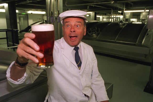 Pictured is international cricket umpire Dickie Bird eyeing up a pint of Tetley's Bitter after opening the Dickie Bird Room at Tetley's Brewery in 1998.