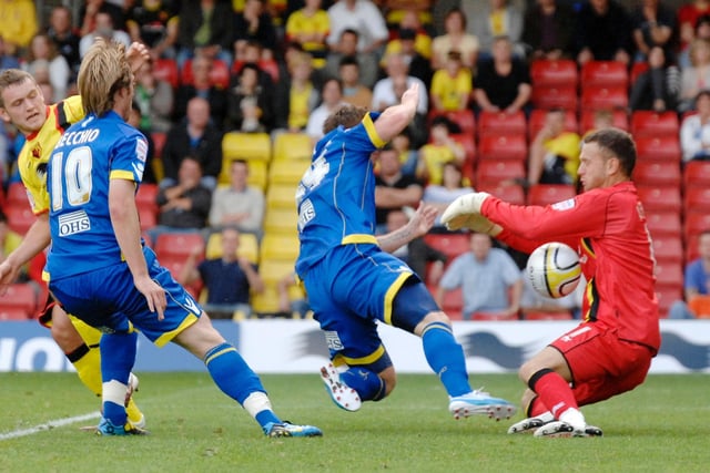 McCormack, centre, is kept out by Watford 'keeper Scott Loach, right, as Becchio, left, looks on.