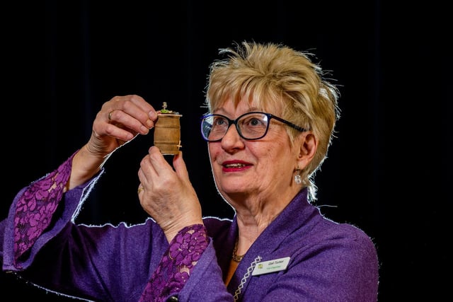 Organiser Gail Tucker and owner of Merry Gourmet Miniatures with an example of her incredibly detailed miniatures from all periods of time.