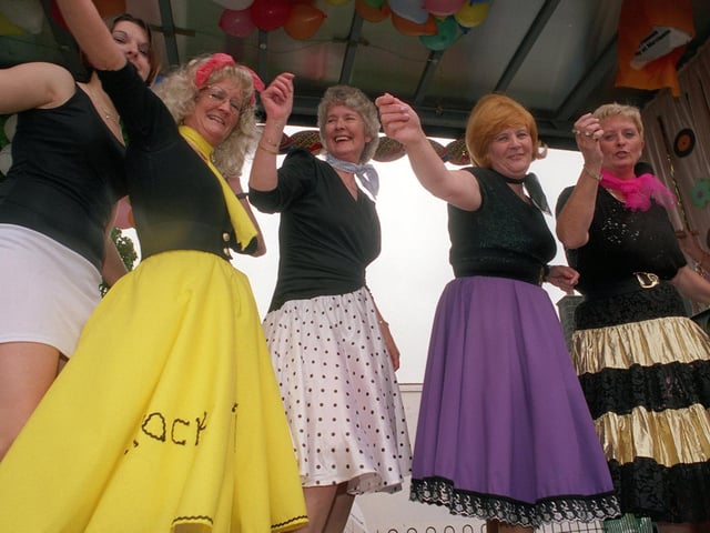 Guiseley factory workers dance on a float during the town's Carnival day in June 1999.