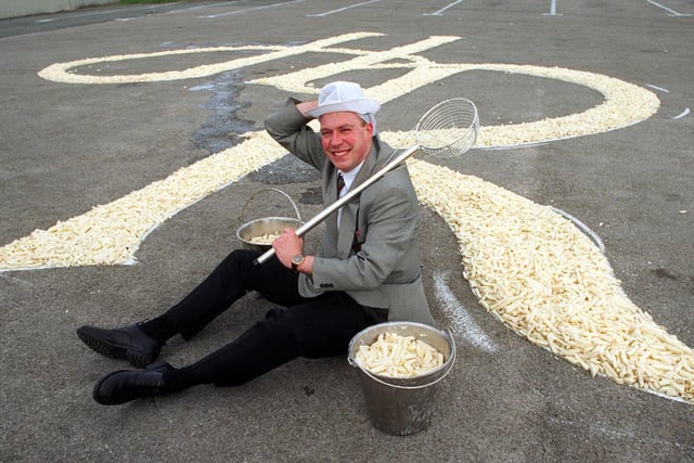 February 1998 and Harry Ramsden's marketing manager Bob Acrey is pictured with a 30ft signature of chips in the car park of the restaurant.