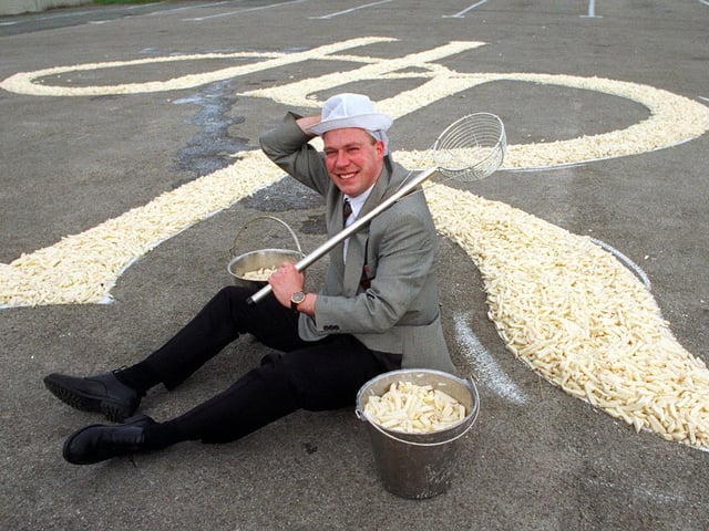 February 1998 and Harry Ramsden's marketing manager Bob Acrey is pictured with a 30ft signature of chips in the car park of the restaurant.