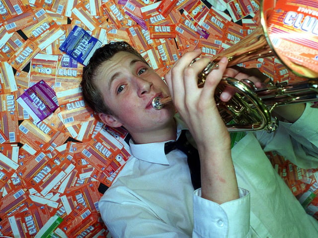 Cornet player Mark Howorth celebrates pupils at Guiseley School eating 17,000 chocolate bars in exchange for musical instruments.