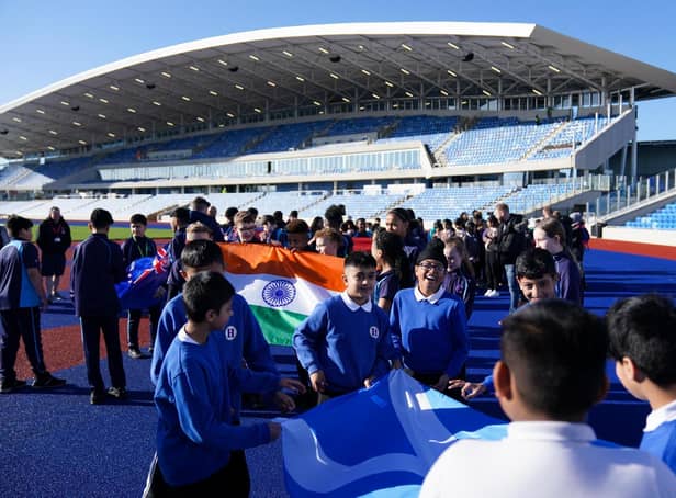 Pupils from schools in Birmingham carry Commonwealth member nations flags as they celebrate Commonwealth Day at the Alexander Stadium, the venue for the Opening/Closing Ceremonies and the athletics programme for the Commonwealth Games which will begin on 28 July 2022.