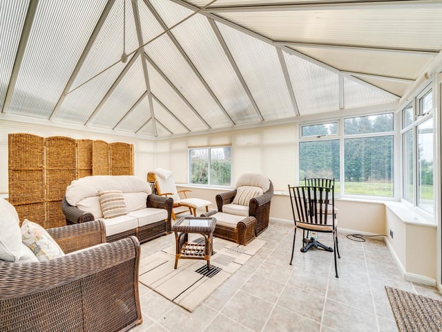 The garden room, to the rear of the property, leads out into the sloping southerly facing gardens.