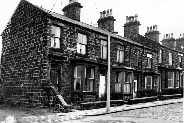 Stone built properties on the odd numbered side of Wesley Terrace in March 1965. On the left an unmade road gives access to back entrances and gardens.