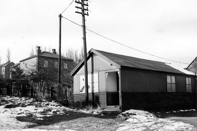 This wooden building on Wesley Street pictured in March 1965 had until recently been the surgery of Dr  Ambrose Bateman. Club Lane can be seen through the trees