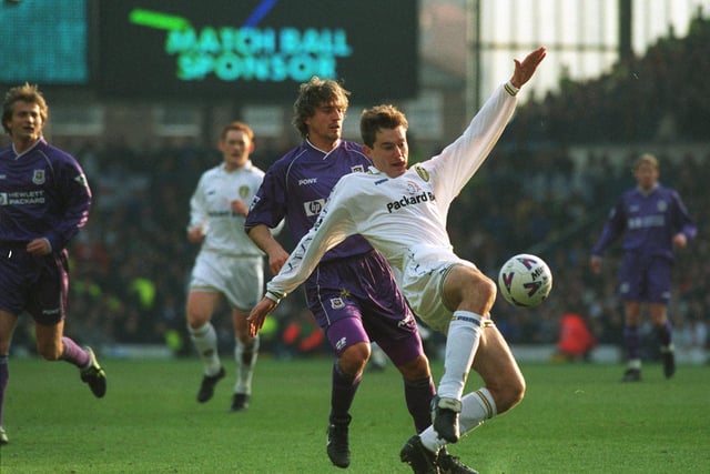 David Wetherall shoots at goal watched by Tottenham's David Ginola in the FA Cup tie at Elland Road.