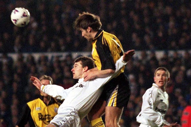 Darren Bradshaw of Rushden and Diamonds climbs on the shoulders of David Wetherall during the FA Cup third round replay at Elland Road in January 1999. Leeds won 3-1. PIC: John Giles/PA