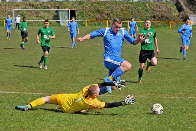Sam Thorpe of Whitkirk is brought down by Beeston Parkside FC goalkeeper Damian Frost for a penalty. Picture: Steve Riding.