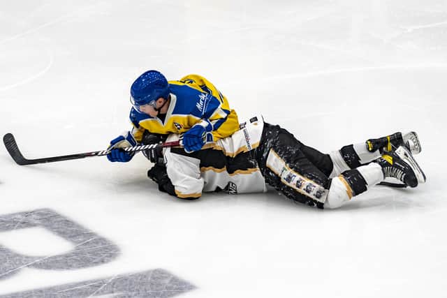 DOWN BUT NOT OUT: Jordan Griffin finishes his check on a Milton Keynes opponent, but Leeds Knights need to win their remaining four play-off games to stand a chance of making it through to the NIHL National play-off finals weekend in Coventry on April 30. Picture courtesy of Oliver Portamento.