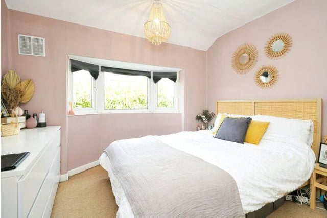 Upstairs are three bedrooms. The first room is a spacious double painted in a soft muted pink.