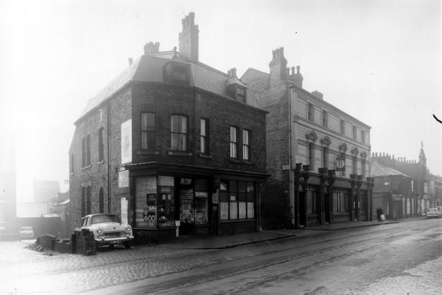Queens Palace is on the left edge of this view from January 1961. Moving right is a greengrocers and general store then Albert Gardner, fried fish dealer. Next, the entrance to Queen's Terrace can be seen before the Queen's Hotel.
