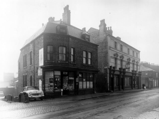 Queens Palace is on the left edge of this view from January 1961. Moving right is a greengrocers and general store then Albert Gardner, fried fish dealer. Next, the entrance to Queen's Terrace can be seen before the Queen's Hotel.