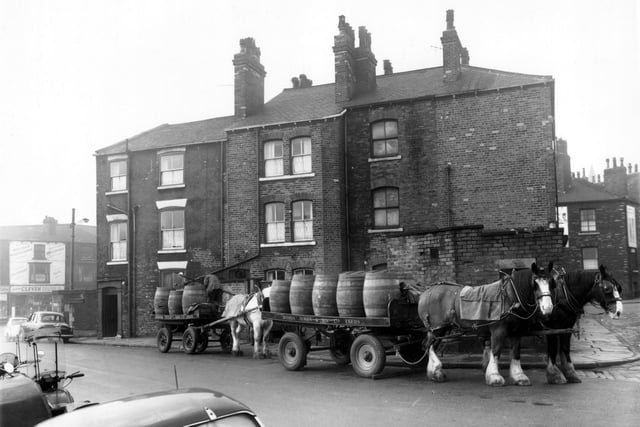This photo looks from Manor Street onto the back of properties on Roundhay Road including the Victoria public house  towards the left in January 1961.  A delivery is being made from the Joshua Tetley and Son brewery by their traditional shire-horse drawn carts.