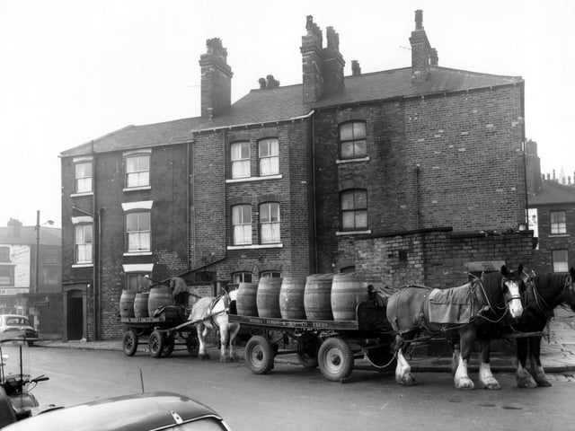 This photo looks from Manor Street onto the back of properties on Roundhay Road including the Victoria public house towards the left in January 1961. A delivery is being made from the Joshua Tetley and Son brewery by their traditional shire-horse drawn carts.