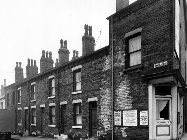 Houses on Enfield Road in February 1961. On the corner is the premises of H.G. Hosiery Co.