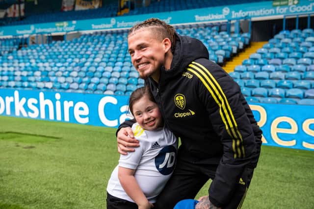Leeds United midfielder Kalvin Phillips embraces a young fan. Pic: Leeds United Football Club.