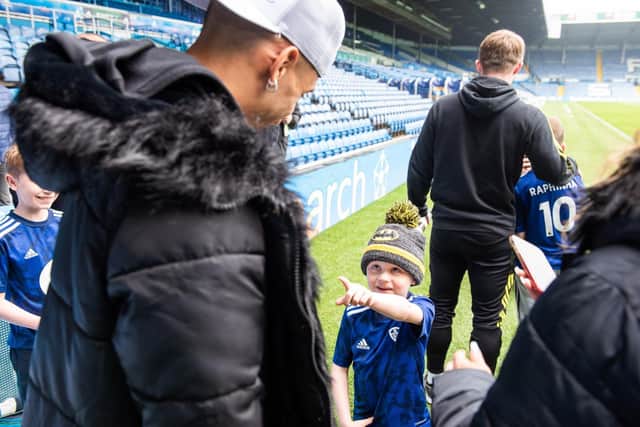 Leeds United winger Raphinha greets a young fan at Elland Road. Pic: Leeds United Football Club.