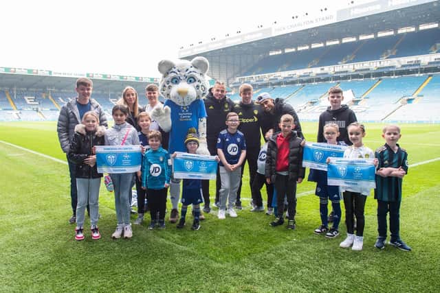Young Leeds United fans affected by cancer pose with Whites stars on the pitch at Elland Road. Pic: Leeds United Football Club.