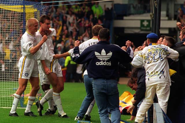 David Wetherall celebrates his goal with teammate Alf Inge Haaland and the Elland Road faithful. PIC: Bruce Rollinson