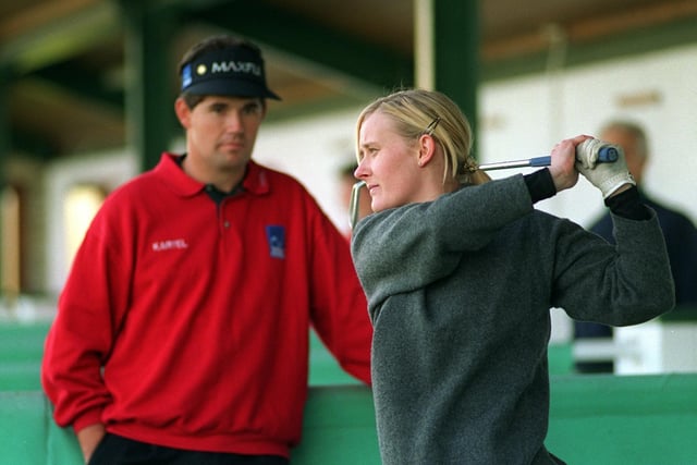 Three times major champion Padraig Harrington watches on as Janine Todd takes a swing at the Leeds Golf Centre where he was giving free golf lessons.