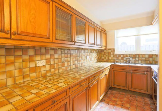 At the rear is the Kitchen with a wide range of wall and base storage fittings along with a built in oven and hob unit.