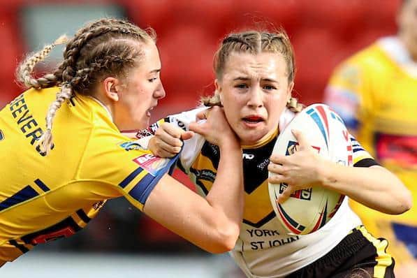 Rhinos' Caitlin Beevers, left, tackles Georgie Hetherington during last year's Super League semi-final. Picture by Paul Currie/SWpix.com.