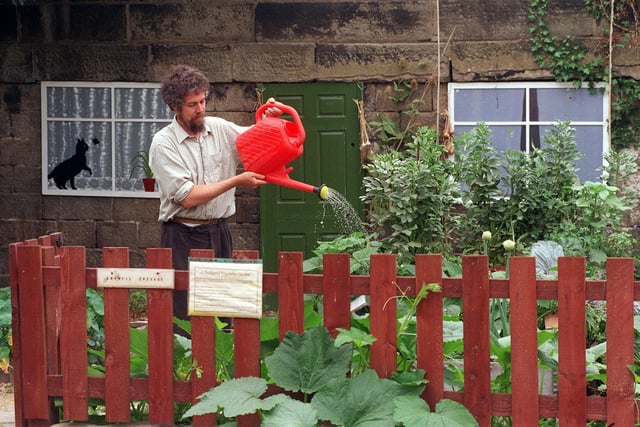 John Preston, of Growing Food, waters the garden of Growfill Cottage at the Hollybush Conservation Centre in Kirkstall in August 1999.